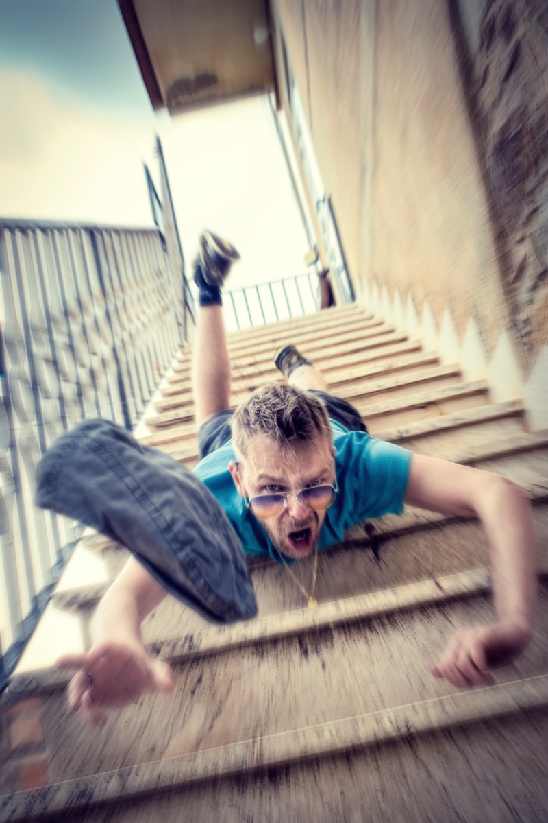 A woman is walking up a set of stairs in a building.